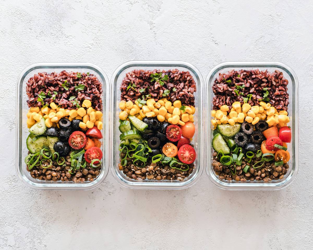 BistroMD Long Term Diet Meals arranged on a kitchen counter with fresh vegetables and water bottle